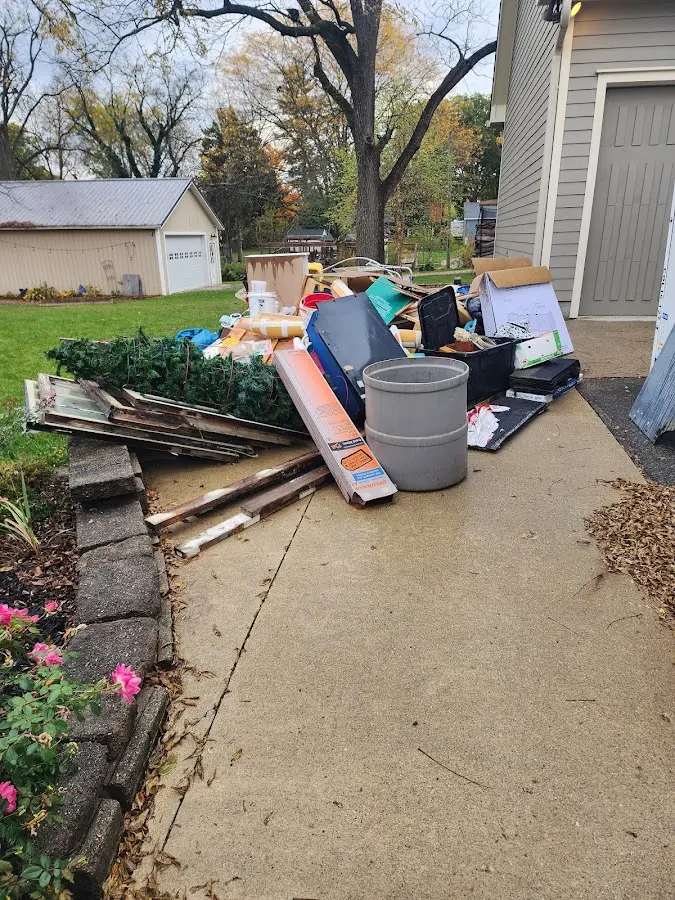Dumpster being loaded with debris for Estate Cleanout Dumpster Rental in East Aurora